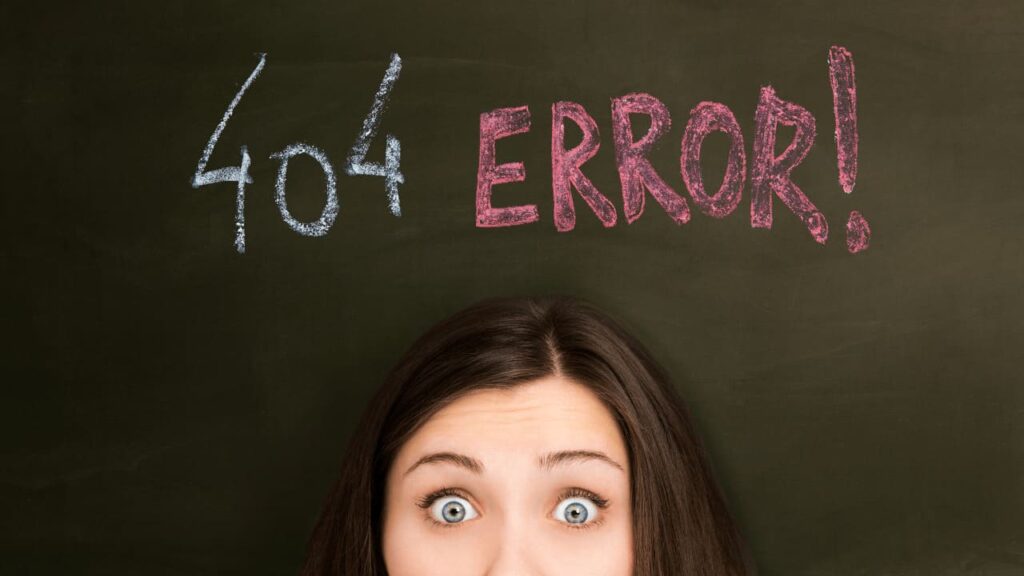 A surprised person looks up at a chalkboard with "404 ERROR!" written in colorful chalk, conveying confusion or mistake online.