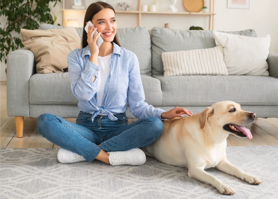 Woman with a dog talking on a phone with LAv1 about SEO