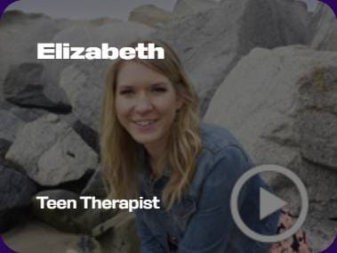 A person sitting in front of large rocks, wearing a denim jacket. Text reads "Elizabeth, Teen Therapist" with a play button icon.