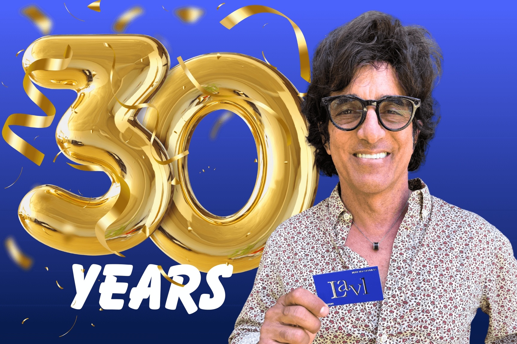 Bruno Pisano, director of Lav1 holding a card stands beside large golden "30 Years" text on a vibrant blue background with confetti.